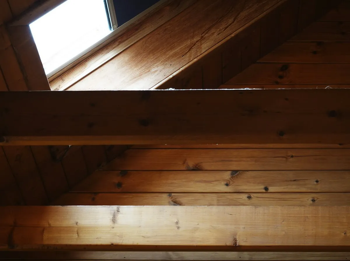 Roof Repair in Lawndale — a roof window and timber rafters in a sloped attic ceiling
