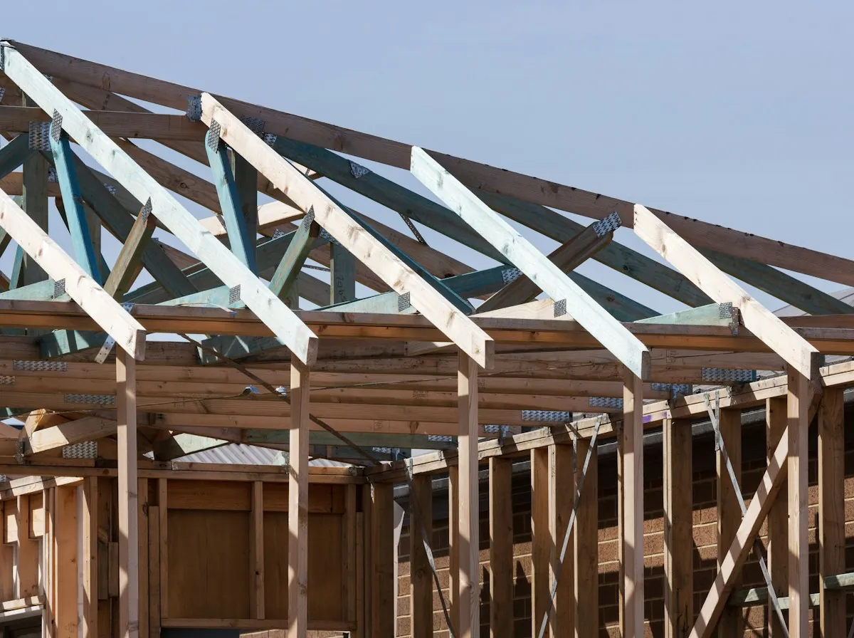 Shingle Roof Repair in Lawndale — new rafters on the frame of a house under construction