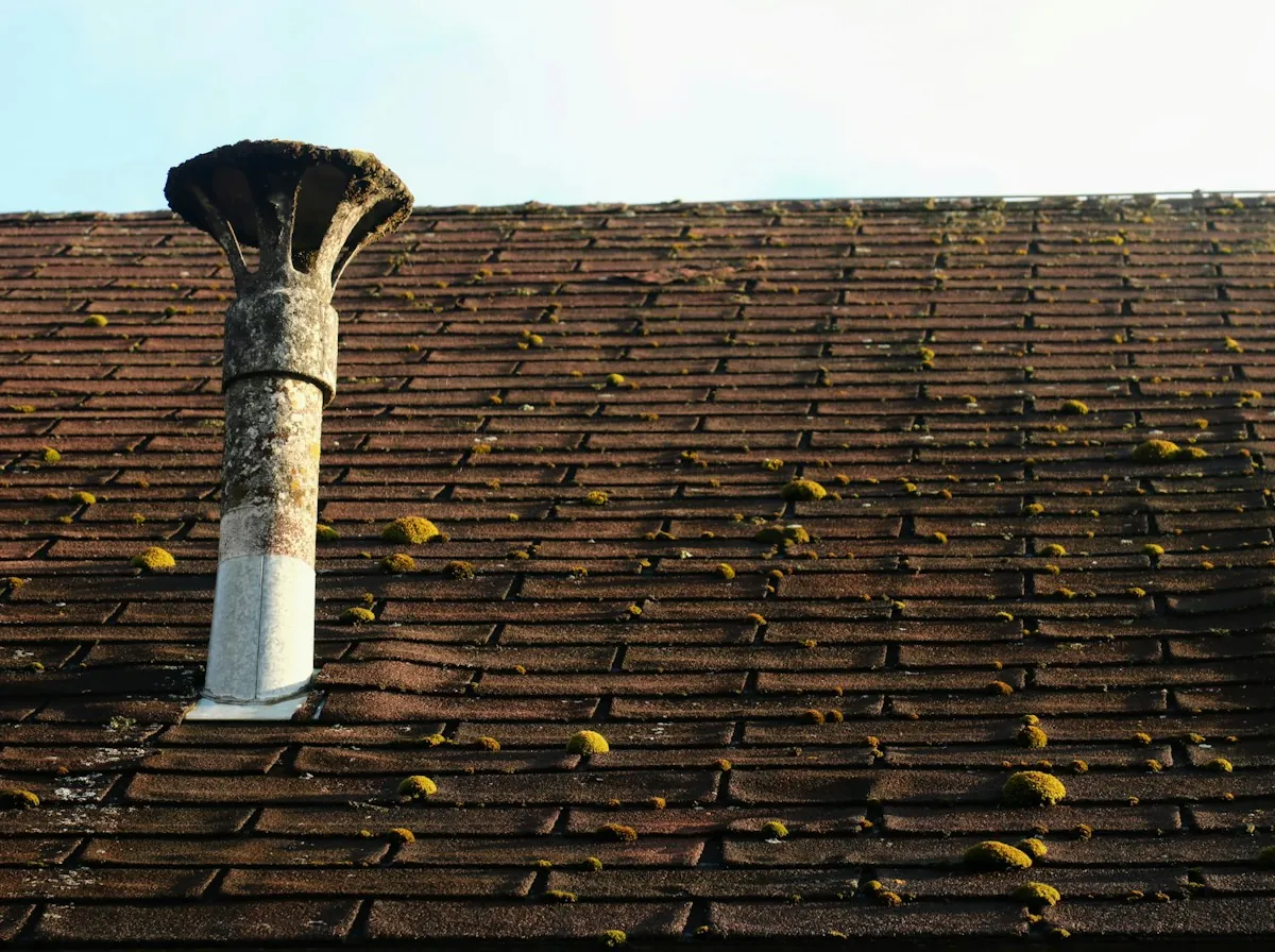 Roof Repair in Lawndale — a weathered vent pipe and its collar on an aging shingle roof